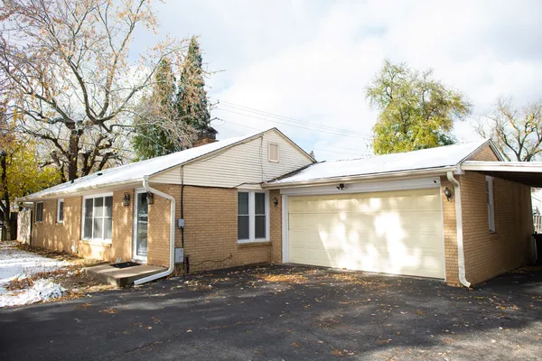 a view of a house with a yard and garage