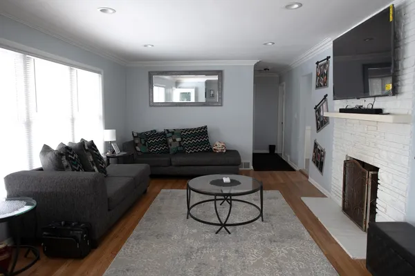 a living room with furniture a fireplace and a flat screen tv
