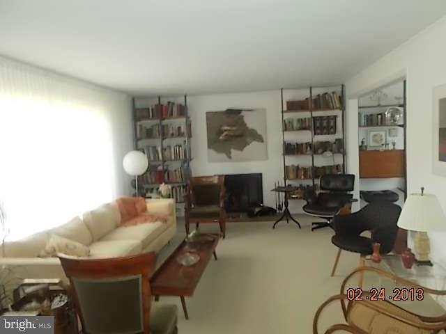 6218 Benhurst Road Baltimore, MD 21209 - Photo 2 of 13 a living room with furniture a rug and a large window