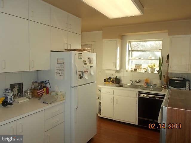 6218 Benhurst Road Baltimore, MD 21209 - Photo 4 of 13 a kitchen with stainless steel appliances a sink stove and refrigerator