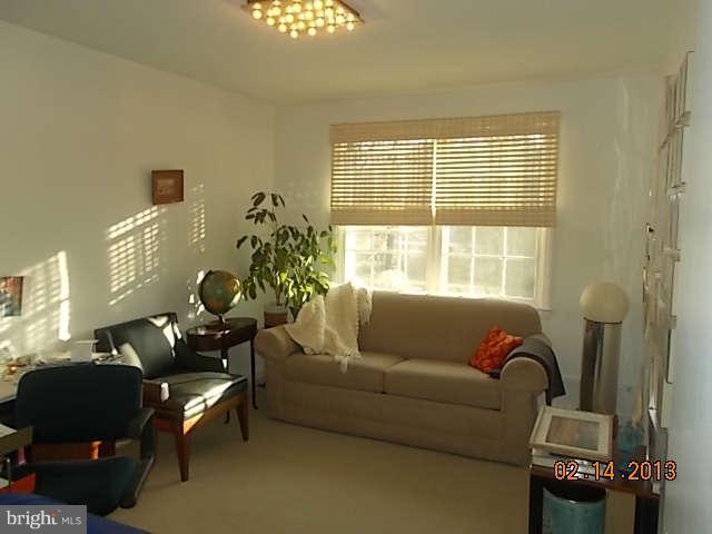 6218 Benhurst Road Baltimore, MD 21209 - Photo 7 of 13 a living room with furniture and a window