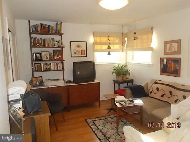 6218 Benhurst Road Baltimore, MD 21209 - Photo 8 of 13 a living room with furniture and a flat screen tv