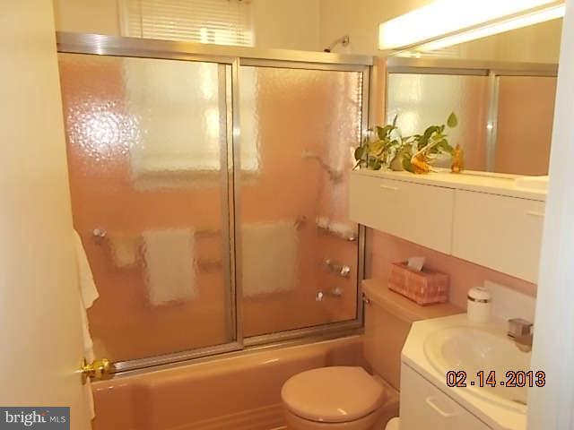 6218 Benhurst Road Baltimore, MD 21209 - Photo 9 of 13 a bathroom with a granite countertop sink toilet and shower