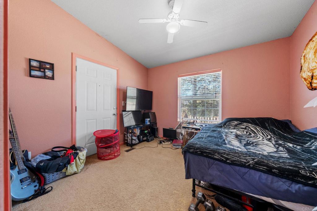 22002 Lyons Valley Road Alpine, CA 91901 - Photo 29 of 75 a bedroom with a bed and a window