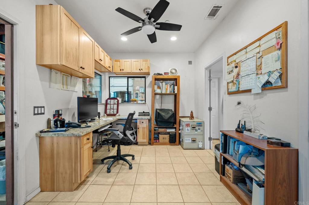 22002 Lyons Valley Road Alpine, CA 91901 - Photo 36 of 75 a view of a workspace with furniture and a ceiling fan