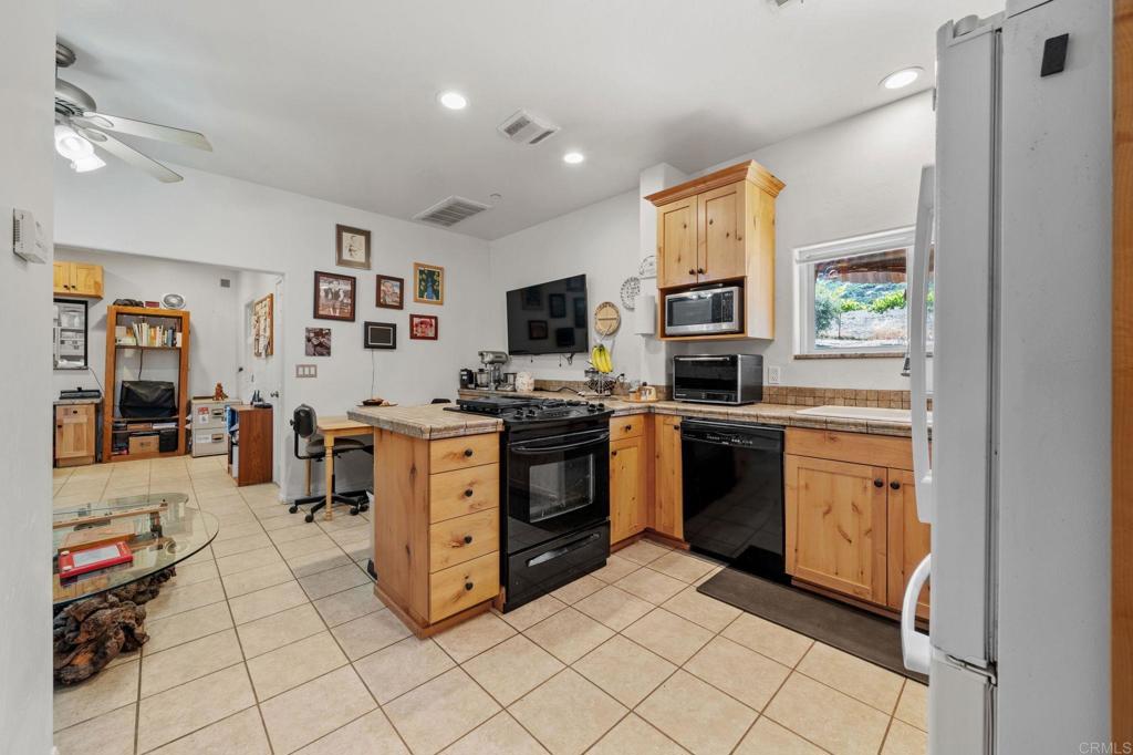 22002 Lyons Valley Road Alpine, CA 91901 - Photo 44 of 75 a kitchen with stainless steel appliances a stove a sink and a refrigerator