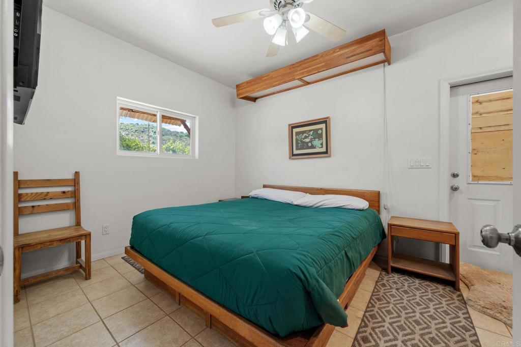 22002 Lyons Valley Road Alpine, CA 91901 - Photo 47 of 75 a bedroom with a bed and a chair