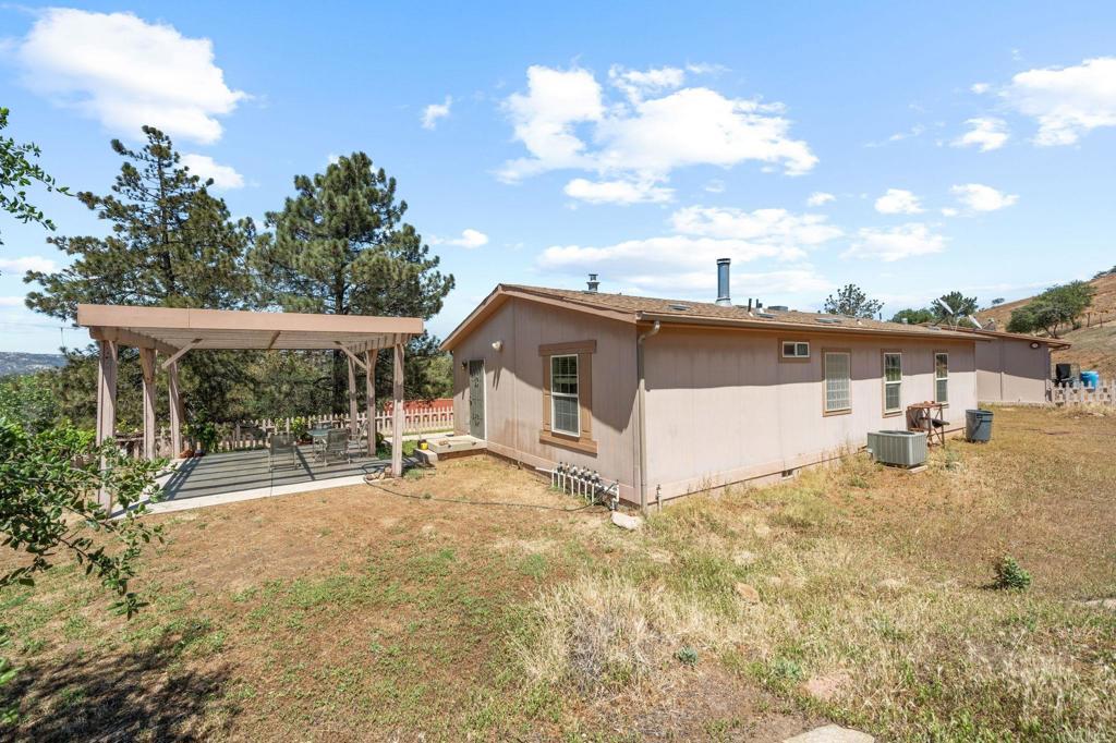 22002 Lyons Valley Road Alpine, CA 91901 - Photo 7 of 75 a view of a house with a backyard and sitting area