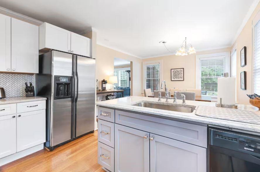 152 Ponce De Leon Court Decatur, GA 30030 - Photo 2 of 3 a kitchen with a sink stainless steel appliances white cabinets and a window