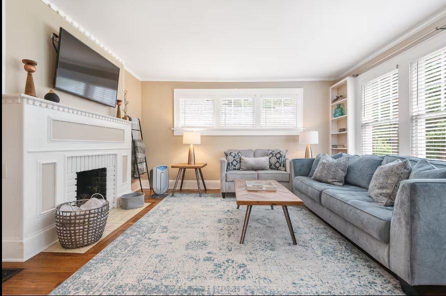 152 Ponce De Leon Court Decatur, GA 30030 - Photo 3 of 3 a living room with furniture a flat screen tv and a fireplace