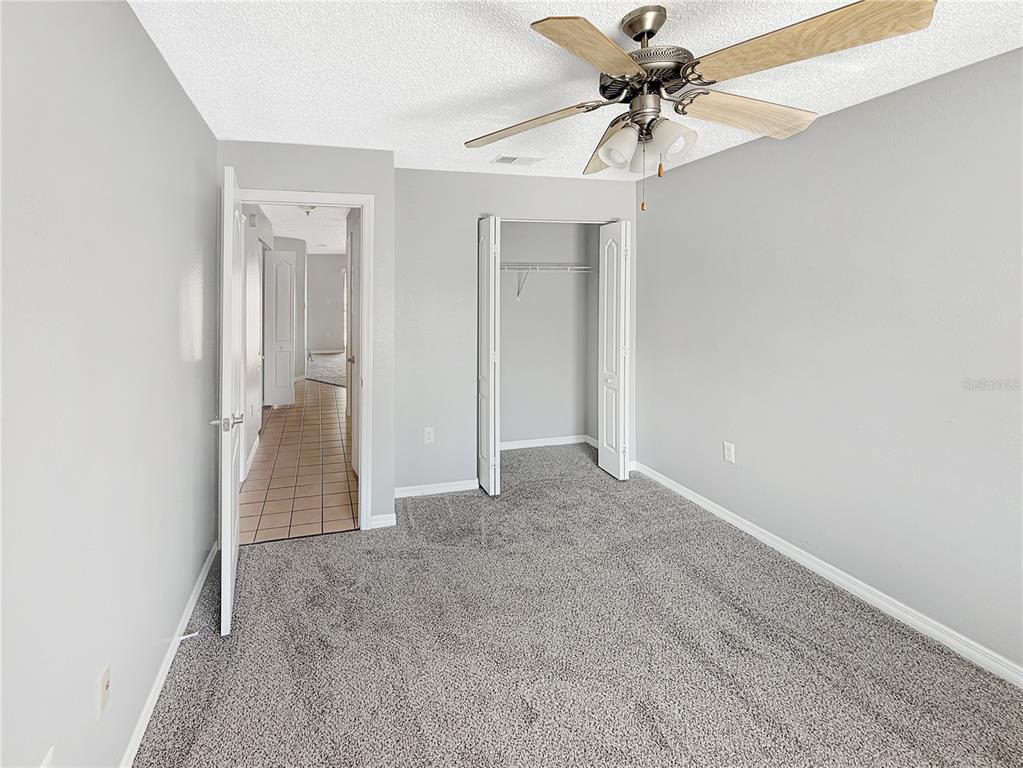 90 Hidden Lake Drive, Unit 132 Sanford, FL 32773 - Photo 11 of 13 an empty room with fan and entryway