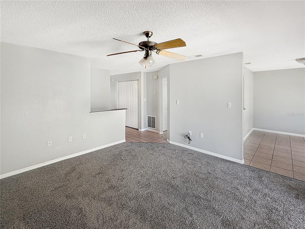 90 Hidden Lake Drive, Unit 132 Sanford, FL 32773 - Photo 3 of 13 a view of an empty room with a ceiling fan