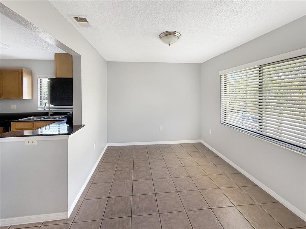 90 Hidden Lake Drive, Unit 132 Sanford, FL 32773 - Photo 4 of 13 a view of an empty room with a window and a kitchen