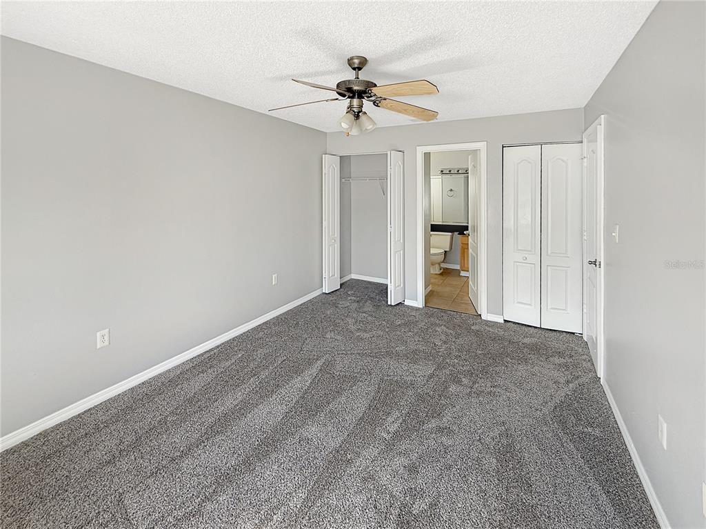 90 Hidden Lake Drive, Unit 132 Sanford, FL 32773 - Photo 9 of 13 a view of an empty room with a ceiling fan