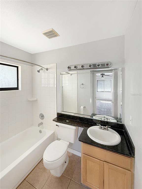 90 Hidden Lake Drive, Unit 132 Sanford, FL 32773 - Photo 10 of 13 a bathroom with a sink toilet a mirror and bathtub