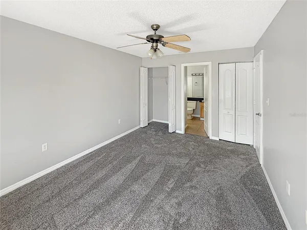 a view of an empty room with a ceiling fan