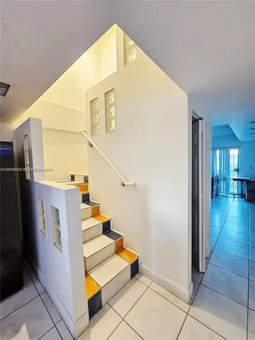 a view of a room with wooden floor and white walls