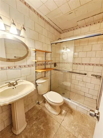 a bathroom with a toilet sink and mirror