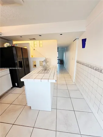 a view of washer and dryer with bathtub in a room