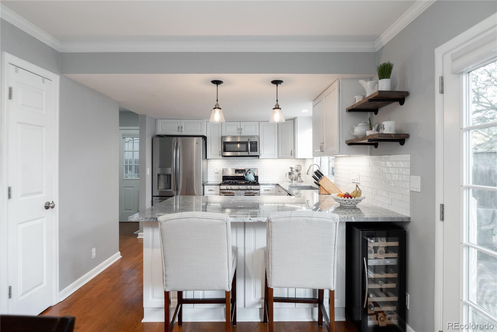 2696 Perry Street Denver, CO 80212 - Photo 17 of 40 a kitchen with stainless steel appliances granite countertop a refrigerator and a stove top oven