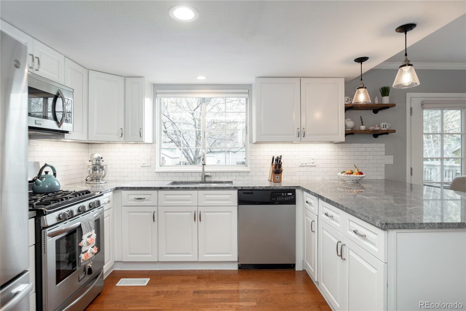 2696 Perry Street Denver, CO 80212 - Photo 19 of 40 a kitchen with white cabinets appliances and a window