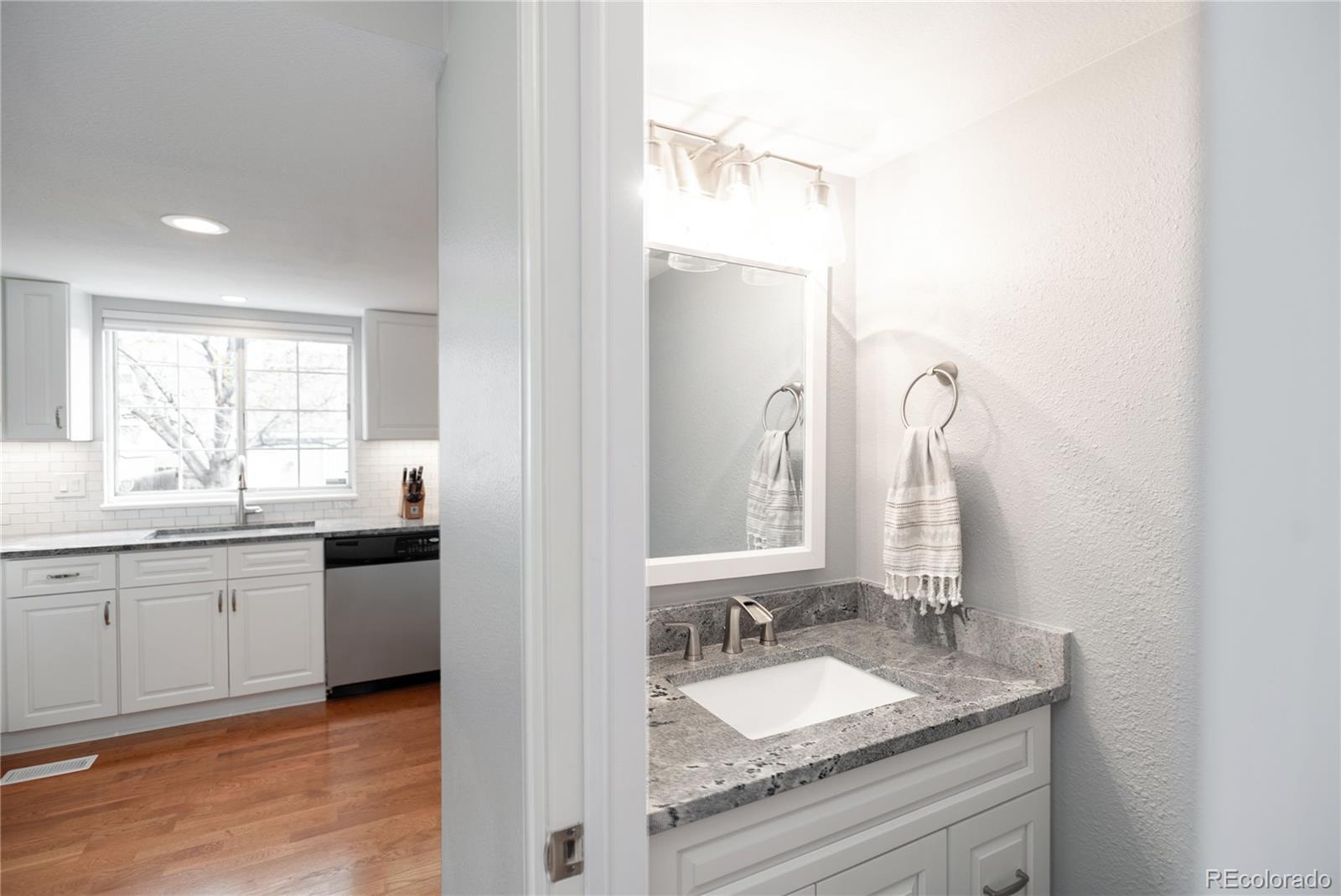 2696 Perry Street Denver, CO 80212 - Photo 20 of 40 a bathroom with a granite countertop sink double and mirror