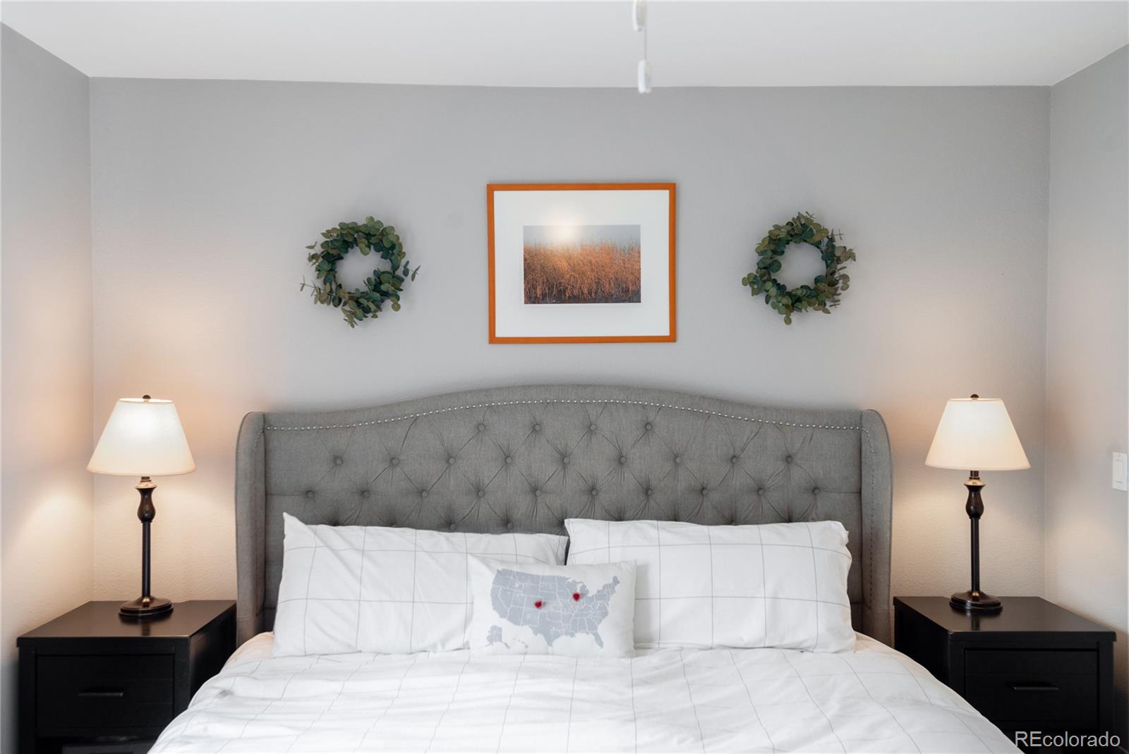 2696 Perry Street Denver, CO 80212 - Photo 22 of 40 a bedroom with a bed and a lamp