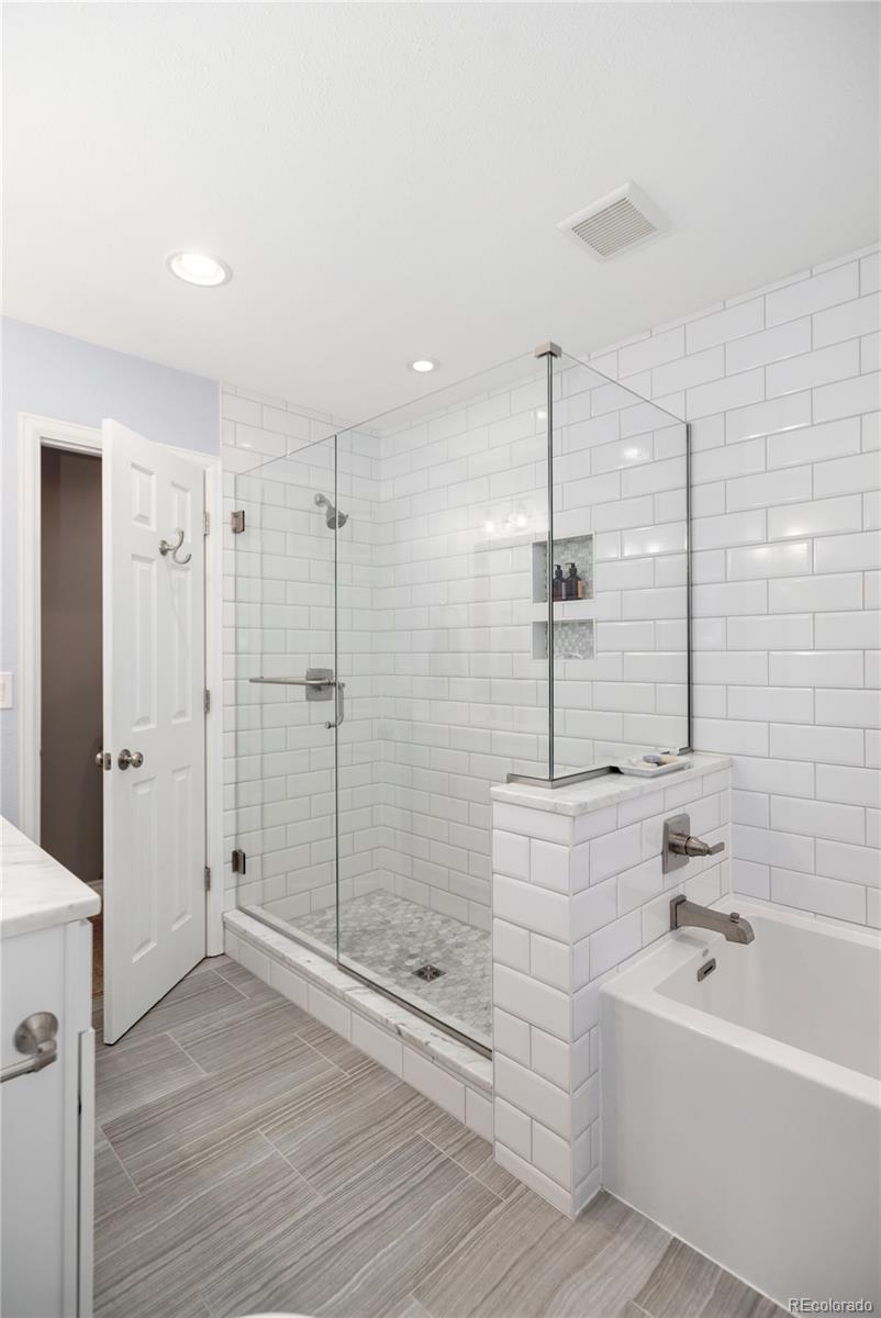 2696 Perry Street Denver, CO 80212 - Photo 23 of 40 a bathroom with a bathtub and a shower