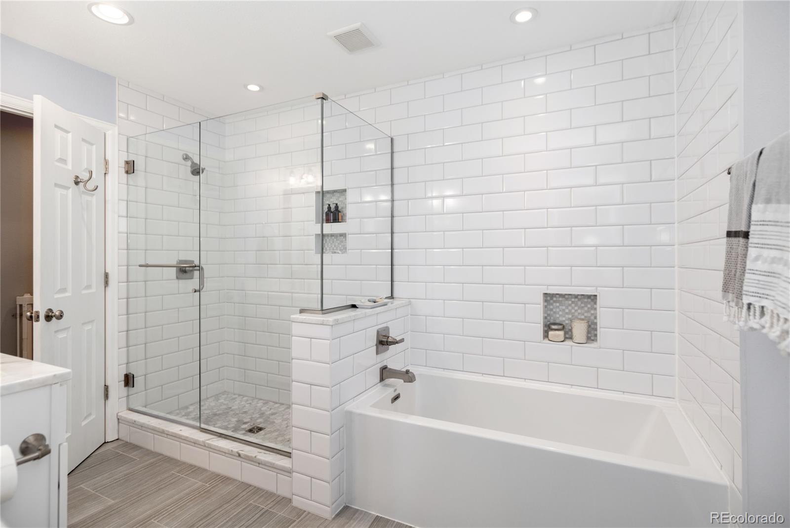 2696 Perry Street Denver, CO 80212 - Photo 26 of 40 a bathroom with a bathtub and shower