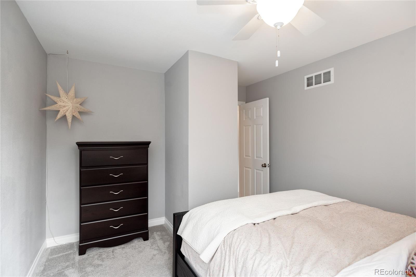 2696 Perry Street Denver, CO 80212 - Photo 28 of 40 a bedroom with a bed and a dresser