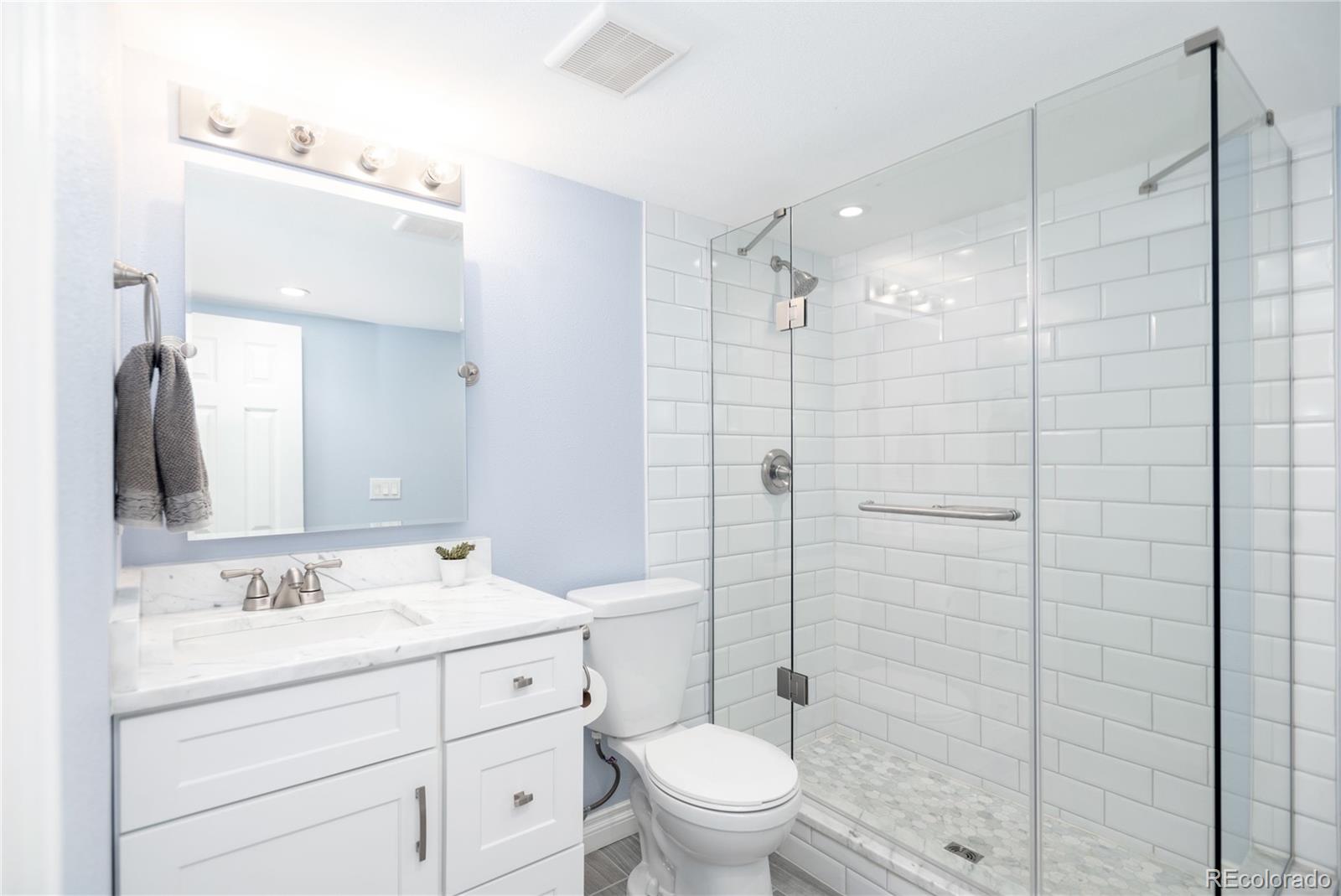 2696 Perry Street Denver, CO 80212 - Photo 35 of 40 a bathroom with a toilet sink shower and mirror