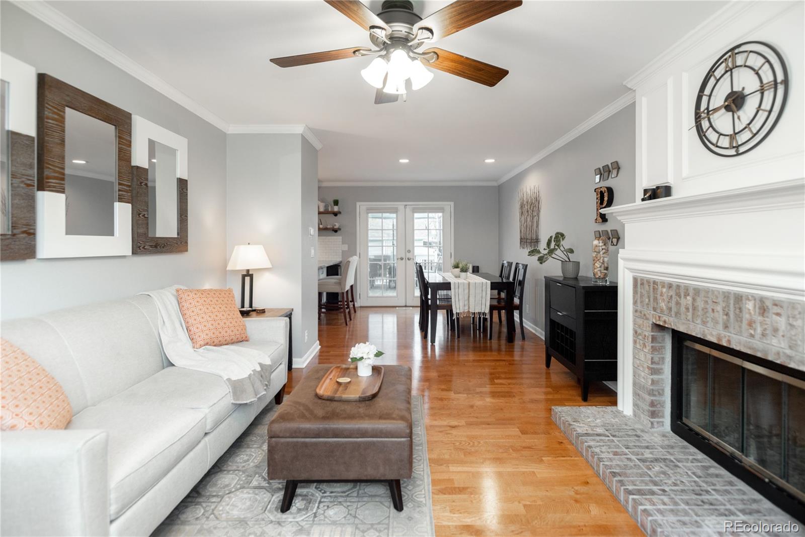 2696 Perry Street Denver, CO 80212 - Photo 10 of 40 a living room with furniture a clock and a fireplace