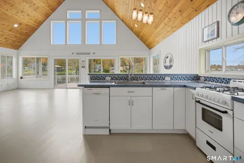 a open kitchen with stainless steel appliances granite countertop a stove and cabinets
