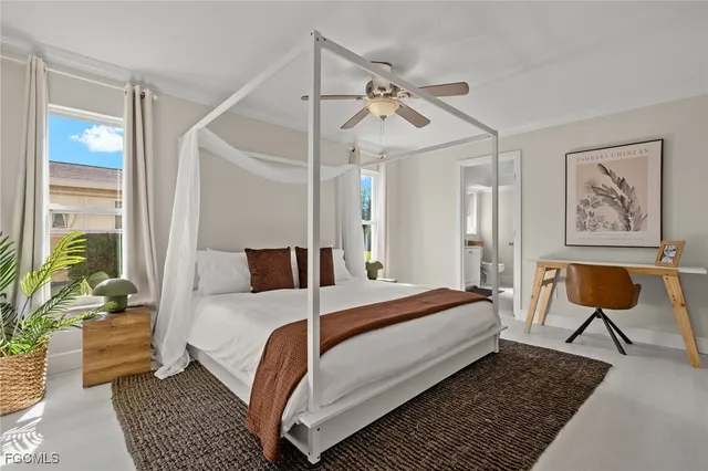 a bedroom with a bed a table and chair