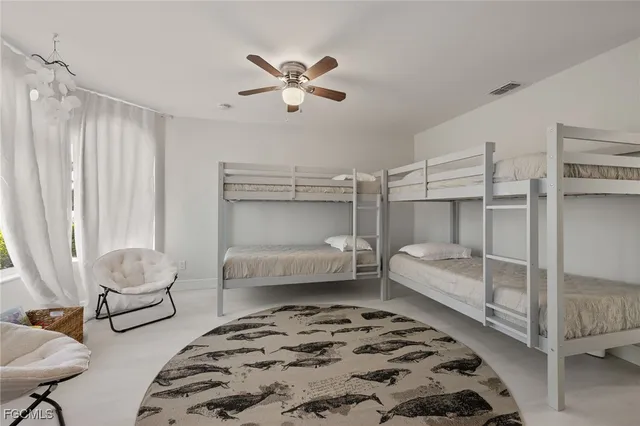 a bedroom with bed and a chandelier