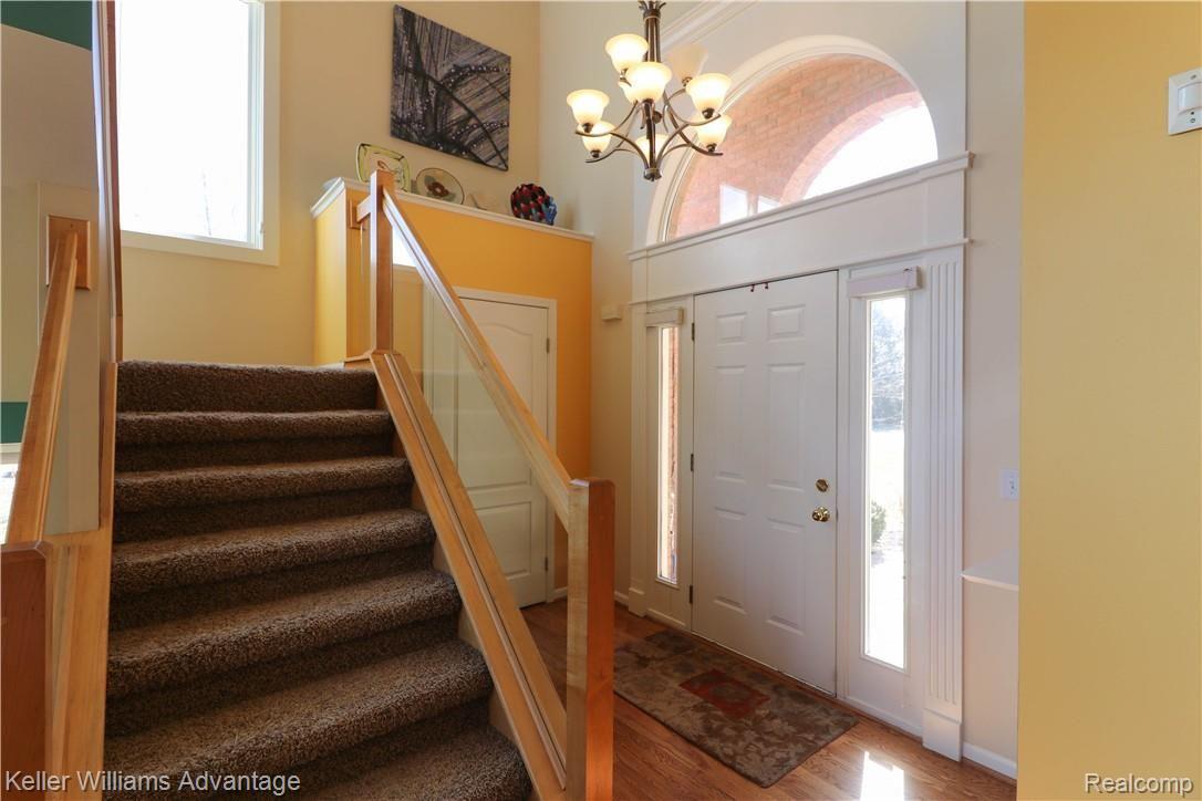 8932 Cooley Lake Road White Lake, MI 48386 - Photo 6 of 36 Bright, sunny entryway leads to the inviting great room, with easy access to upstairs and downstairs!