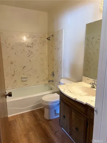 a bathroom with a granite countertop toilet sink and bathtub