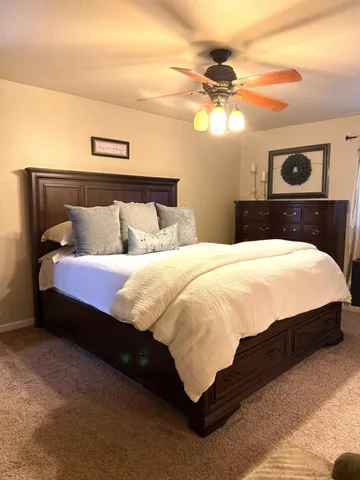 a bedroom with a bed and a chandelier