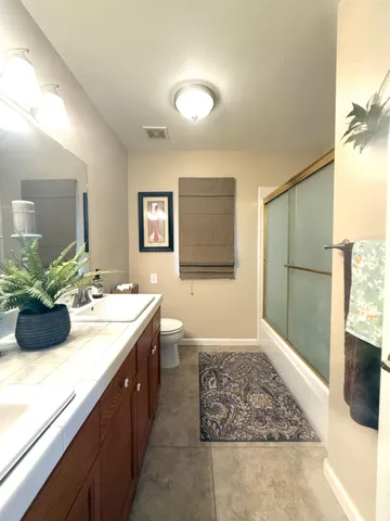 a bathroom with a double vanity sink and a mirror