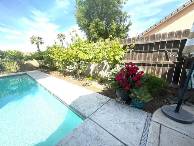 a view of backyard with swimming pool