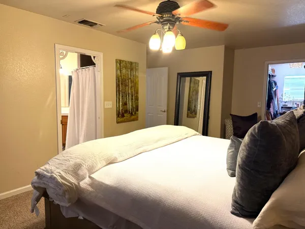 a bedroom with a bed and window