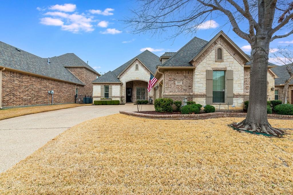 805 Merion Drive Fort Worth, TX 76028 - Photo 1 of 1 a front view of a house with a yard and garage