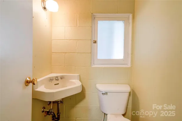 a bathroom with a sink toilet and mirror