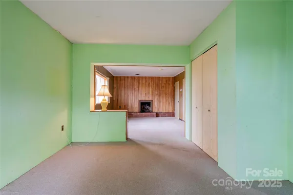 a view of a room with a window and a kitchen