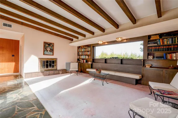 a living room with furniture and a book shelf
