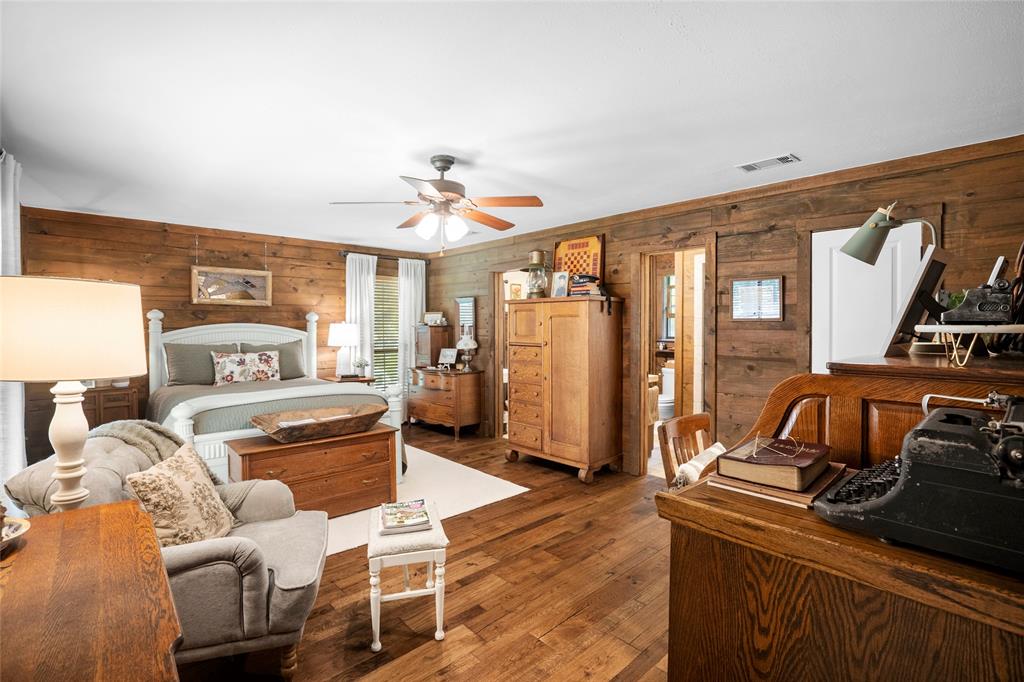 1516 Rancho Road Quinlan, TX 75474 - Photo 15 of 40 a bedroom with furniture and wooden floor