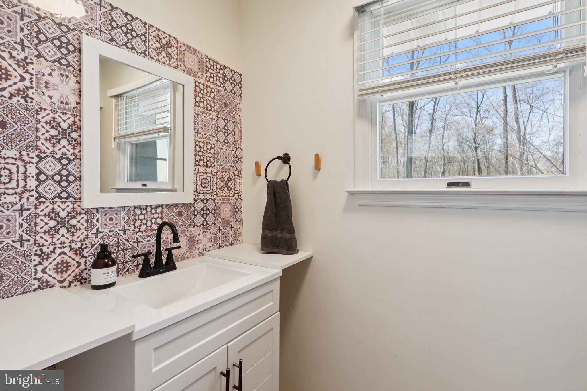 351 Merrick Road Robbinsville, NJ 08691 - Photo 30 of 69 a bathroom with a sink and a mirror
