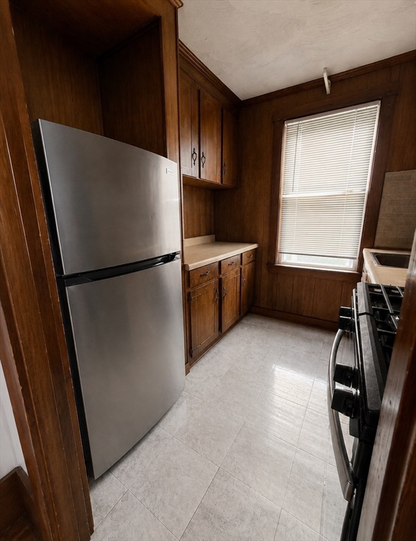 37 Shawmut Street Fall River, MA 02720 - Photo 4 of 16 a kitchen with refrigerator a window and a counter