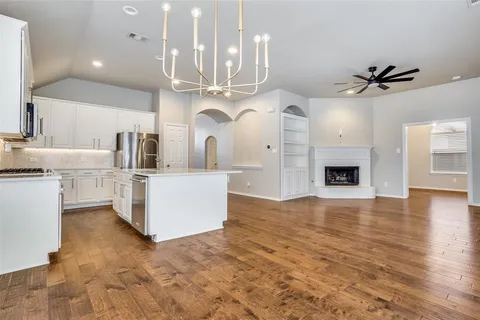 a view of cabinets and kitchen with stainless steel appliances