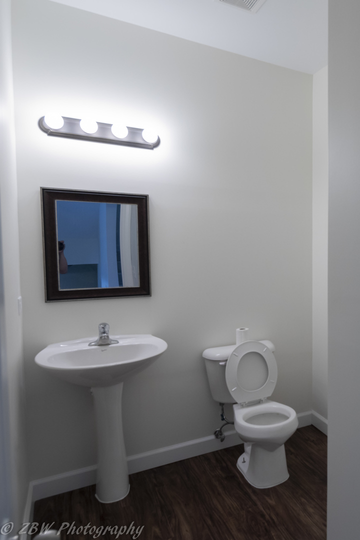 1906 Indian Hill Lane, Unit 1906 Aurora, IL 60503 - Photo 2 of 13 a bathroom with a toilet sink and mirror